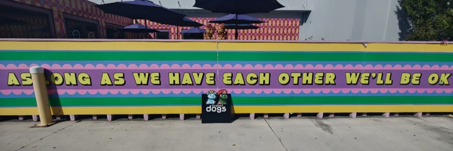 Doginal Dogs mural — MetalXMeta banner Colorful mural reading As long as we have each other we'll be ok, with a Doginal Dogs sign in front